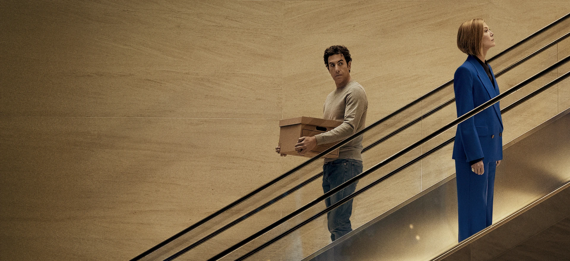A scene from Ladies First on Netflix featuring Sacha Baron Cohen and Rosamund Pike,
illustrating gender role reversal as a tool for laughter therapy and emotional regulation.